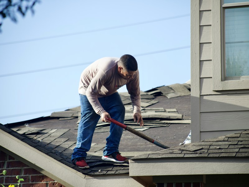 Roofer inspecting tiles